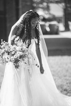 a woman in a wedding dress holding a bouquet