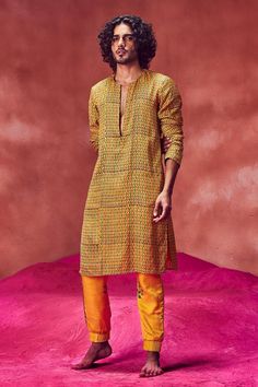 Yellow kurta with hand block print in a wave pattern and zip closure in front. Comes with joggers.
Component: 2
Pattern: Print
Type Of Work: Hand Block Print
Neckline: Round
Sleeve Type: Full
Fabric: Satin Silk
Color: Yellow
Other Details: 
Side slits
Pockets on the sides
Closure: Zip front
Occasion: Mehendi and Puja - Aza Fashions Block Printed Kurta, Punit Balana, Yellow Kurta, Kurta Set For Men, Yellow Satin, Yellow Silk, Ethnic Design, Suit Pant, Nehru Jackets