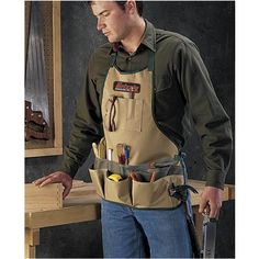 a man wearing an apron with tools in it and holding a tool belt around his waist