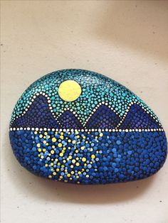 a painted rock sitting on top of a white table