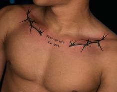 a man with barbed wire on his chest has the words fear no evil but god