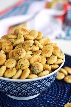 a bowl filled with crackers sitting on top of a blue and white place mat