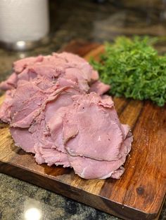 some meat is on a wooden cutting board