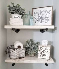 two shelves with towels, toilet paper and other bathroom items on top of each shelf