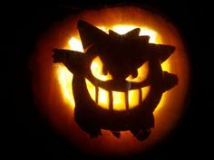 a pumpkin carved to look like an angry cat