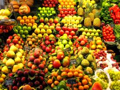 many different types of fruits and vegetables on display