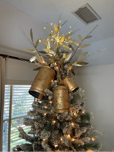 a christmas tree decorated with bells and lights