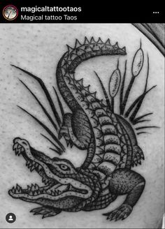 a black and white photo of a dragon tattoo