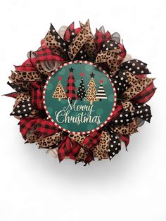 a christmas wreath with leopard print and red, black and green plaid bows on it