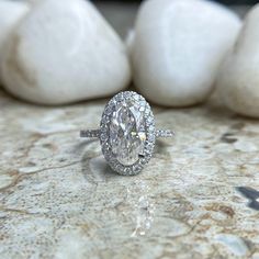 a diamond ring sitting on top of a marble counter