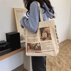 a woman carrying a tote bag with pictures on it