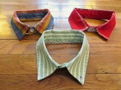 three ties laid out on a wooden floor