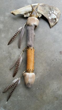 an animal bone with feathers attached to it