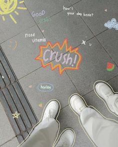 two people standing in front of a sidewalk with chalk drawings on it and the words croh written below