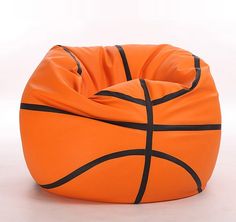 an orange basketball bean bag chair with black lines on the bottom and sides, sitting in front of a white background