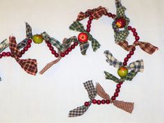 several pieces of fabric with apples and bows on them