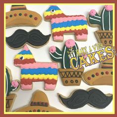 decorated cookies are arranged in the shape of horses, mustaches, and cactuses