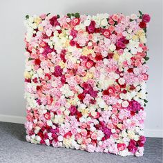 a large flower covered wall in the shape of a square with many flowers all over it