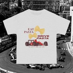 Introducing the ultimate t-shirt for the passionate Formula One enthusiast - a blend of style, comfort, and a dash of humor. Crafted with the motorsport aficionado in mind, this t-shirt is a must-have for anyone who loves the exhilarating world of Formula One. Designed to make a statement, the t-shirt features a bold and vibrant graphic that reads "Eat Pasta, Drive Fasta - The Life of Carbs and Cars." This catchy slogan perfectly captures the essence of a true Formula One fan's passion for both the high-speed excitement on the racetrack and the indulgence in delicious carbs. Made from high-quality, breathable cotton, this shirt ensures optimal comfort whether you're cheering for your favorite team at the track or lounging at home. The stylish design incorporates sleek racing-inspired eleme Casual Short Sleeve T-shirt For Motorsport Events, Racing Style T-shirt With Letter Print For Motorsport Events, Racing Style Letter Print T-shirt For Motorsport Events, Racing Style T-shirt For Motorsport Events, Racing Style Graphic T-shirt For Sports Events, Racing Style Graphic Print T-shirt For Sports Events, Racing Style Crew Neck T-shirt For Motorsport Events, Racing Style Fan Merchandise T-shirt With Logo Print, Racing Style Graphic Print T-shirt For Fans