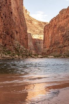 the water is brown in color and it looks like there are cliffs on either side