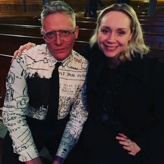 a man and woman sitting next to each other in front of pews at a church