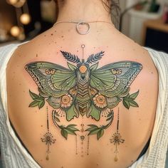 a woman with a butterfly tattoo on her back