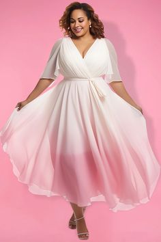 a woman in a white and pink dress posing for the camera with her hands on her hips