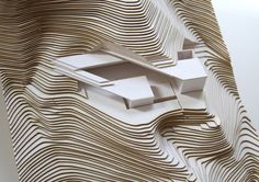 an architectural model of a building with wavy lines on the outside and inside, as if it were cut from paper