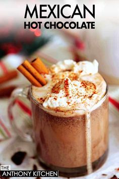 A clear glass mug filled with mexican hot chocolate topped with whipped cream and cinnamon sprinkles. Two cinnamon sticks are resting in the mug. Mexican Hot Chocolate Recipe Abuelita Crock Pot, How To Make Mexican Hot Chocolate, Homemade Mexican Hot Chocolate, Mexican Hot Chocolate Aesthetic, Abuelita Hot Chocolate, Traditional Mexican Hot Chocolate, Mexican Hot Chocolate Recipe, Hot Chocolate Milk, Mexican Wedding Cookies