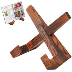 a wooden cross is shown with an open book next to it on a white background