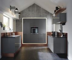 a modern kitchen with grey cabinets and wood flooring is pictured in this image, it appears to be an open concept