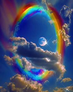 a rainbow in the sky with clouds around it