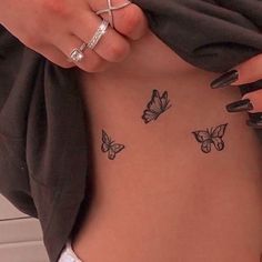 a woman's stomach with butterflies on it