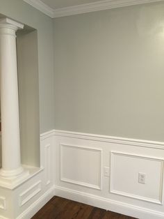 an empty room with wood floors and white trim