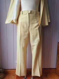 Beautifully preserved suit Excellent condition Pastel yellow Unfortunately without brand label 100% Polyester Size 38 Dimensions lying flat: TROUSERS: Waist size 37 cm/ 14.56 inch Leg inside length: 70 cm/ 27.55 inch Waist to crotch: 29 cm/ 11.41 inch JACKET: Shoulder width: 42 cm/ 16.53 inches Armpit-armpit: 51 cm/ 20.07 inch Length from shoulder: 54 cm/ 21.25 inch Classic Yellow Suit For Work, Classic Yellow Suits For Work, Vintage Fitted Beige Bottoms, Fitted Vintage Beige Bottoms, Yellow Formal Bottoms For Spring, Formal Yellow Bottoms For Spring, Elegant Yellow Formal Pants, Classic Yellow Bottoms For Summer, Formal Yellow Trousers