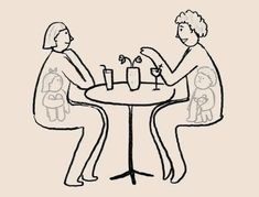 two people sitting at a table with drinks