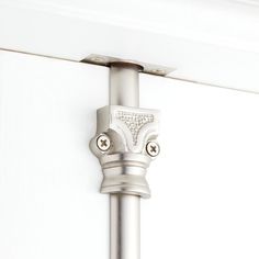 a close up of a metal pole on a white wall