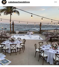 tables and chairs are set up on the beach for an outdoor wedding reception at sunset