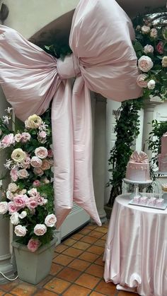 a table topped with pink cakes and flowers