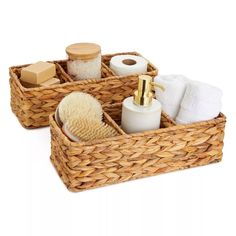 two wicker baskets with soap, toothbrushes and other bathroom items in them