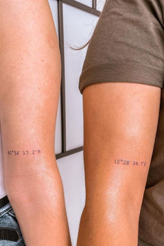 two people standing next to each other with small tattoos on their arms that say it's the best