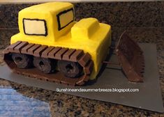 a cake made to look like a bulldozer is sitting on a counter top