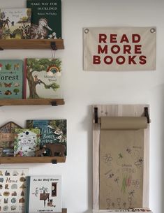 there are many books on the shelves in this children's book room, and one has a sign that says read more books