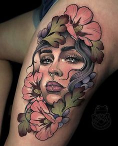 a woman's face with flowers on her thigh