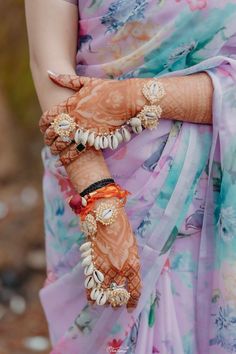 a close up of a person wearing jewelry on their hands