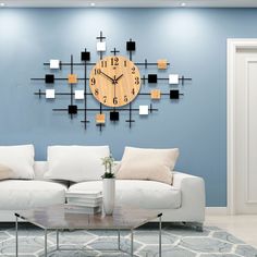 a living room with a white couch and a clock mounted to the wall above it