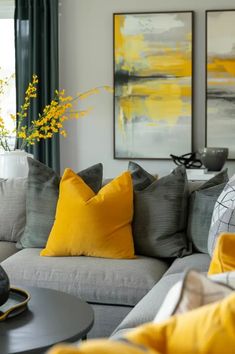 a living room filled with furniture and yellow pillows