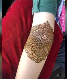 a woman's arm with henna tattoos on it