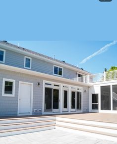 a house with white doors and steps leading up to it