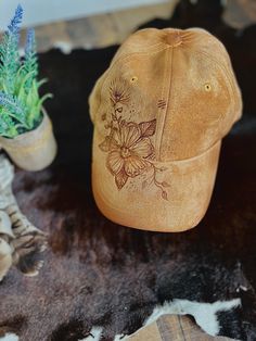 A one-of-a-kind hat, with a unique design hand-burned by our talented artist. Embracing the art of pyrography, this baseball cap is a must-have accessory for any cowboy or cowgirl. Includes an adjustable back strap. We are happy to take custom orders. Please reach out with the design you are looking for!                                                                                          Bundle and save! Do you have a friend or family member who also wants an awesome unique hat? Do you have Vintage Adjustable Distressed Brown Hat, Vintage Baseball Cap For Festivals, Vintage Festival Baseball Cap, Brown Trucker Hat For Festival, Adjustable Hand Dyed Hat With Curved Brim, Hand Dyed Adjustable Hat With Curved Brim, Brown Festival Trucker Hat, Artistic Adjustable Trucker Hat, Hand Painted Snapback Hat